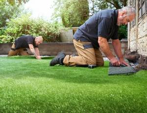two workers Installing artificial grass