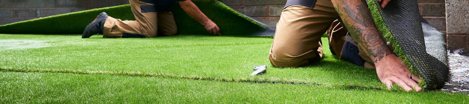 two people installing artificial grass